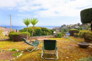 a green lawn chair sitting in a yard at Giardino La Panoramica in Rio Marina