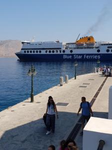 a blue star ferries cruise ship in the water at Danezis Sea Stars Villas New Port in Symi
