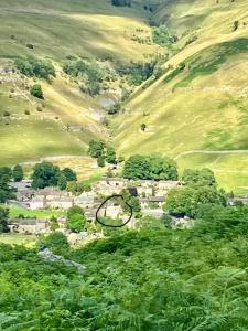 an aerial view of a village in a mountain at The Wharfe at Greystones - Cosy, comfortable retreat in Buckden