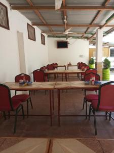 a large conference room with wooden tables and chairs at Golden Guest House- Miritini in Mombasa