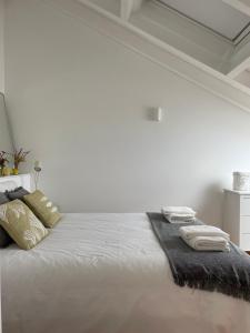 a bedroom with a white bed with towels on it at New! Casa do Mar - Pedralva - Sagres- Surf & Nature in Vila do Bispo +29 photos