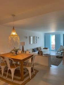 a living room with a table and a couch at New! Casa do Mar - Pedralva - Sagres- Surf & Nature in Vila do Bispo