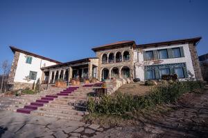 a large stone building with stairs in front of it at Knyazli Family Suites & Rooms in Kiçik Qaramurad