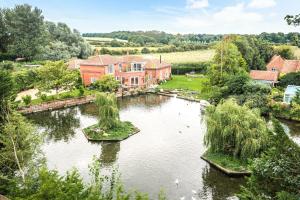 an aerial view of a house with a pond at Lakeside Old Hunstanton in Hunstanton