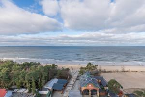 an aerial view of a beach with a building and the ocean at Beachfront Apartment Campingowa by Renters in Międzyzdroje