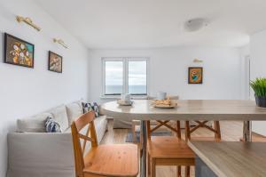 salon ze stołem i kanapą w obiekcie Apartament przy Plaży - Campingowa - Widok na Morze by Noclegi Renters w mieście Międzyzdroje +15 zdjęć