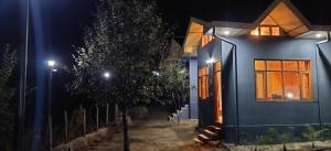 a blue house with a tree in front of it at night at Lacasa Luxury Stays in Shogi