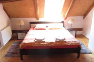 a bedroom with a large bed with two lamps at Pension U Starýho Dubu in Jindřichŭv Hradec