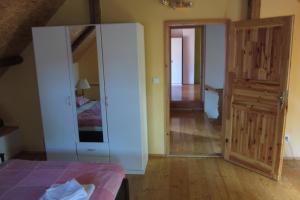 a bedroom with a white cabinet and a mirror at Pension U Starýho Dubu in Jindřichŭv Hradec