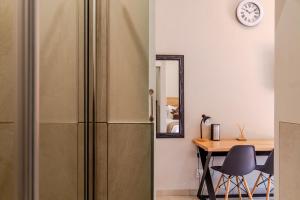 a refrigerator in a kitchen with a table and a mirror at Guest On Wynne in Centurion