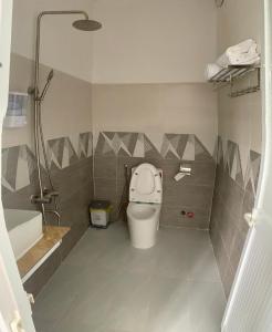 a bathroom with a toilet and a shower and a tub at Hải Phong hotel in My Luong