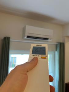 a person holding a scale in front of a room at Modernes Apartment mit besonderem Charme - 1A Guesthouse 