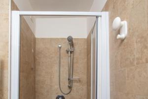 a shower in a bathroom with a glass door at Relais Borgo Campello in Campello sul Clitunno