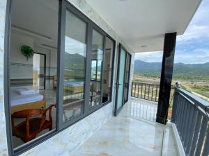 a balcony with a view of the mountains at Hải Phong hotel in My Luong +20 photos