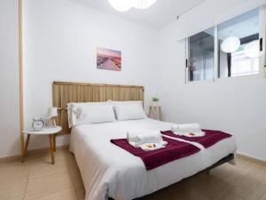 een slaapkamer met een groot bed met twee borden erop bij Adorable apartment 60m from the beach WIFI in Puerto de Sagunto