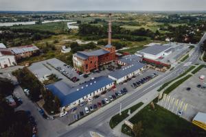 an aerial view of a building with a parking lot at Cukrownia in Opole Lubelskie