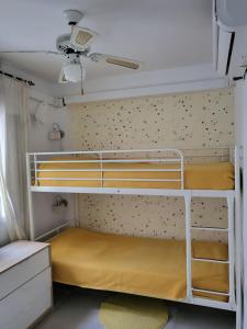 a bedroom with two bunk beds in a room at Selina in Torremolinos