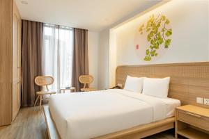 Ένα ή περισσότερα κρεβάτια σε δωμάτιο στο Jacayl Hotel TCG
