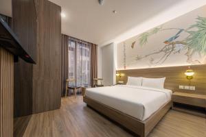 Ένα ή περισσότερα κρεβάτια σε δωμάτιο στο Jacayl Hotel TCG