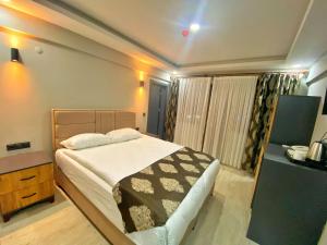 a bedroom with a large bed and a dresser and a bed sidx sidx sidx at Whitestone Hotel in Nevsehir