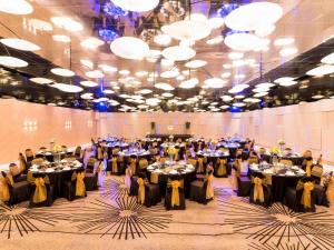 a large banquet hall with tables set for a party at Pullman Pattaya Hotel G in North Pattaya