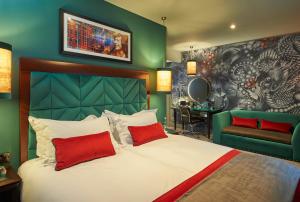 a bedroom with a bed and a green wall at Malmaison Manchester in Manchester