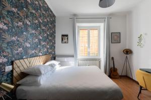 a bedroom with a large bed with a floral wallpaper at Domus Vaticana in Rome