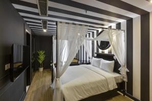 Ένα ή περισσότερα κρεβάτια σε δωμάτιο στο Jacayl Hotel TCG