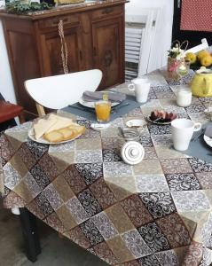 a table with a table cloth with food on it at Casa Bienvenida - La Fallera in Carcagente