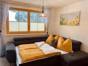 a living room with a couch and a window at Apartment Silberwald in Steinberg am Rofan