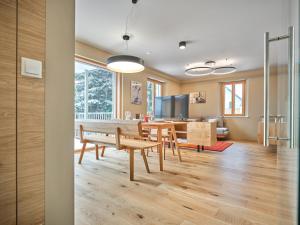 a dining room and kitchen with a table and chairs at Mountain Lover two in Tauplitz