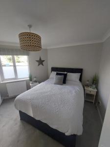 a bedroom with a large bed and a star on the wall at 1 WATER PUMP HOUSE in Bury Saint Edmunds