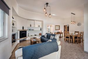 a living room with a couch and a dining room at Celina by Algarve Villa Holidays in Guia
