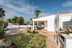 a backyard with a swimming pool and a white house at Celina by Algarve Villa Holidays in Guia