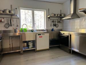 a kitchen with a sink and a stove at Fulufjällsgården in Mörkret