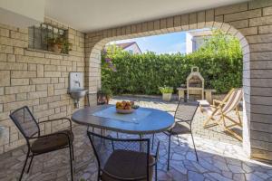 an outdoor patio with a table and chairs at One-Bedroom Apartment in Crikvenica XVII in Dramalj