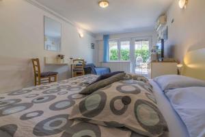 a bedroom with a bed with pillows on it at One-Bedroom Apartment in Crikvenica XVII in Dramalj