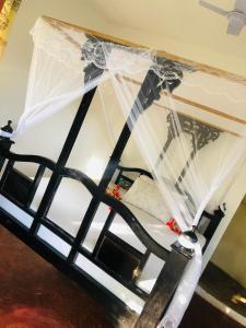a bed with a veil on top of it at The Dream Garden Bungalow in Kizimkazi