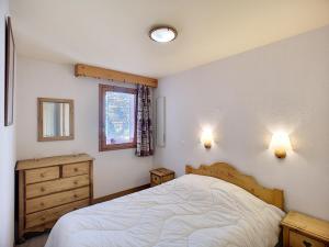 a bedroom with a bed and a dresser and a window at Appartement Les Menuires, 3 pièces, 6 personnes - FR-1-178-319 in Les Menuires