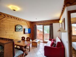 a living room with a couch and a table at Les Alpages de Reberty: Superbe 3 Pièces 37m², 2 Chambres, 6 Pers, Piscine, Spa, Hammam, Saunas - FR-1-178-328 in Les Menuires