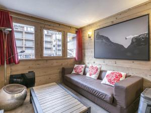 a living room with a couch and two windows at Appartement Val-d'Isère, 3 pièces, 6 personnes - FR-1-519-31 in Val-d'Isère