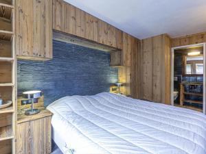a bedroom with a large bed and a brick wall at Appartement Val-d'Isère, 3 pièces, 6 personnes - FR-1-519-31 in Val-d'Isère