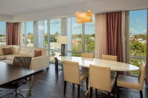 a living room with a table and chairs and a couch at The Limited Hotel in Charleston