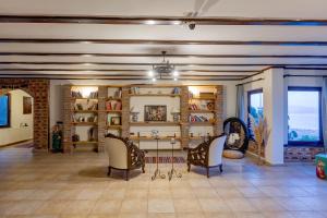 a room with two chairs and a table and shelves at Papazlıkhan Hotel in Altınoluk