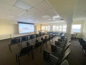 a lecture room with chairs and a projection screen at Курортный отель Coocoorooza in Sochi