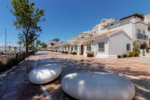 two large white objects sitting on the side of a street at Room in Guest room - Private room in the fishing port of Marbella in Marbella