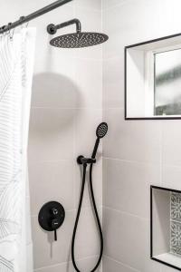 a shower with a blow dryer in a bathroom at Hawaii Dream Escape! Steps from the Sand in Hauula