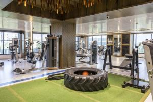 a gym with a large tire in the middle at Ramee International Surat in Surat