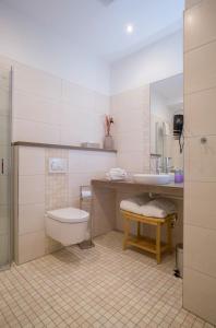 a bathroom with a toilet and a sink at Gasthaus Rech in Eppelborn