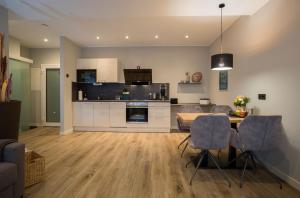 a kitchen and living room with a table and chairs at Gasthaus Rech in Eppelborn